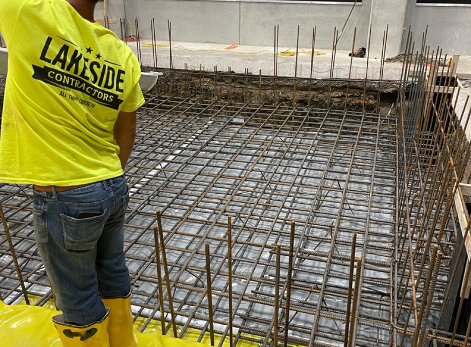 Concrete foundation being laid in a parkin garage